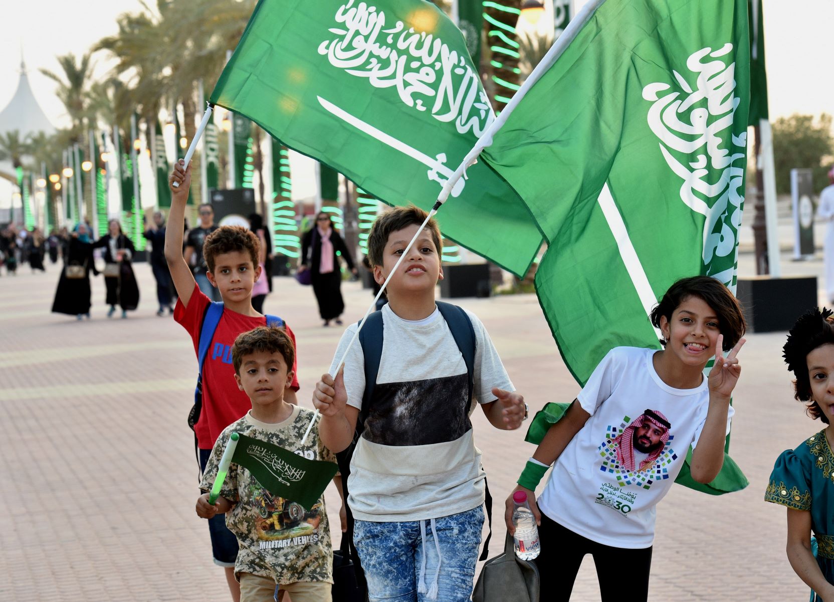 People from all over the world join in on the celebrations of the 89th Saudi National Day. (AFP)