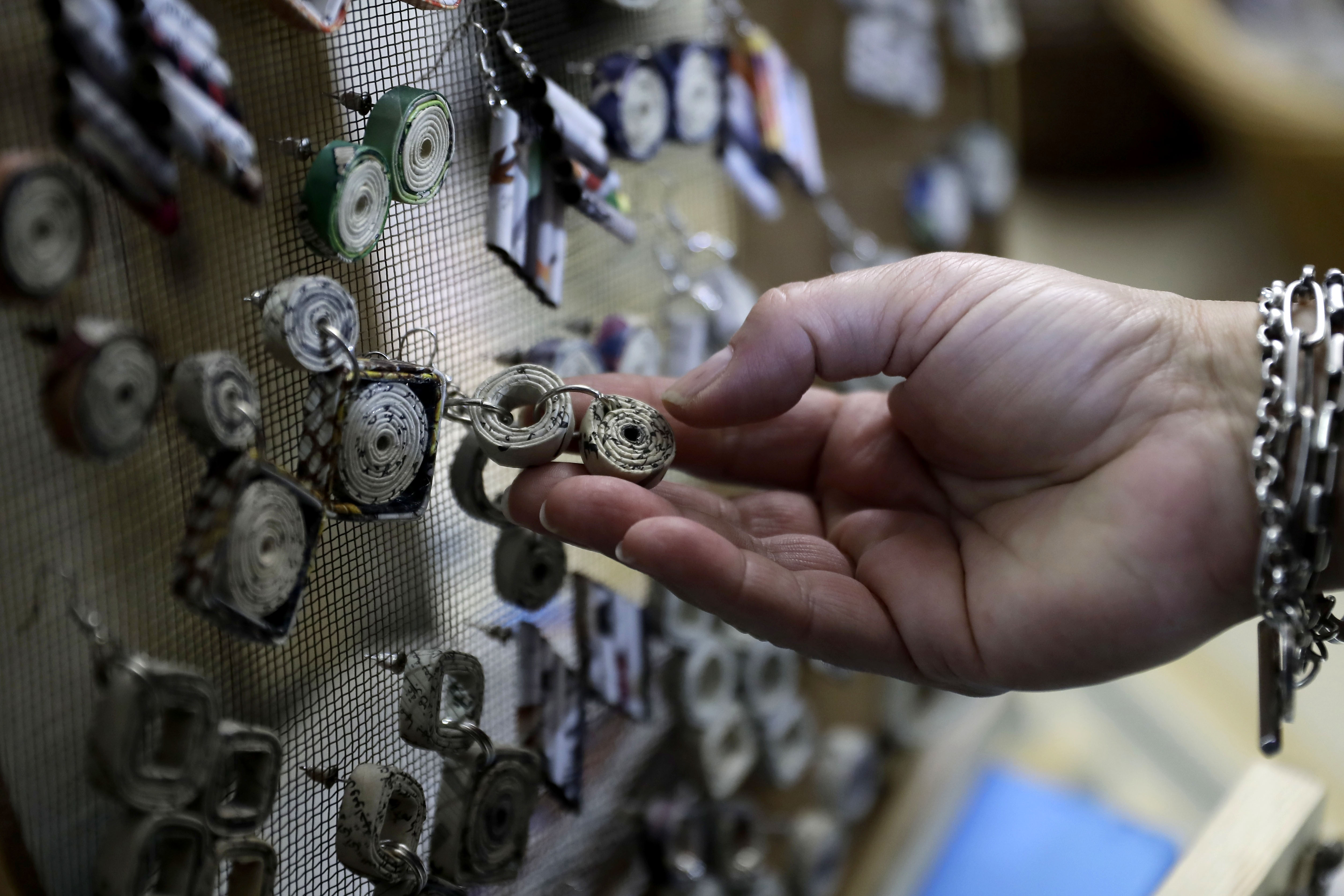 A woman inspects jewelry made out of recycled materials during the opening of the Eco Souk shop in Beirut on February 06, 2019. (File photo: AFP)