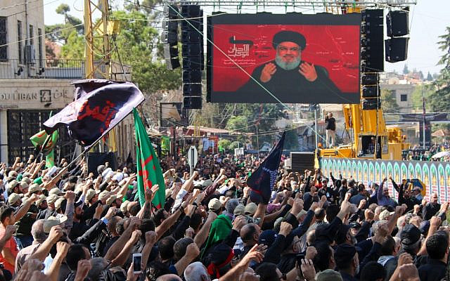 Shiite Muslims watch a televised speech by Hezbollah leader Hassan Nasrallah in the city of Baalbeck in Lebanon’s eastern Bekaa Valley. (AFP)