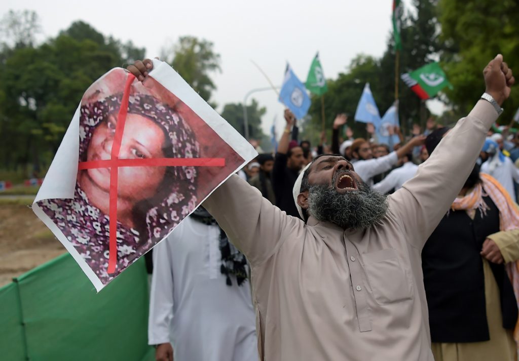 A Pakistani supporter of a hardline religious party holds an image of Asia Bibi during a protest rally in Islamabad on November 2, 2018. (AFP)