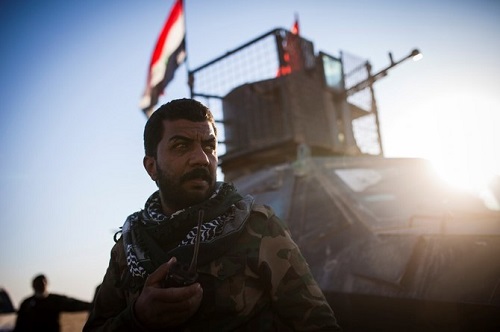 Above, a member of the Al-Hashd Al-Shaabi looks towards the direction of incoming sniper fire at Tal Afar airport in November 20, 2016 file photo. (AFP)