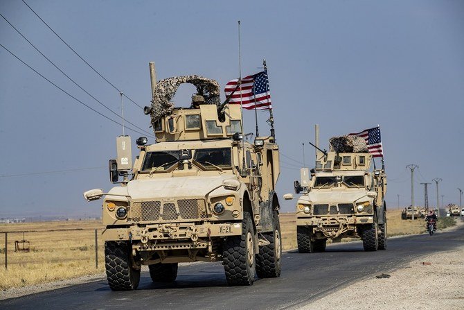 Five armored vehicles bearing US flags patrolled a strip of the frontier north of the town of Qahtaniyah. (File/AFP)