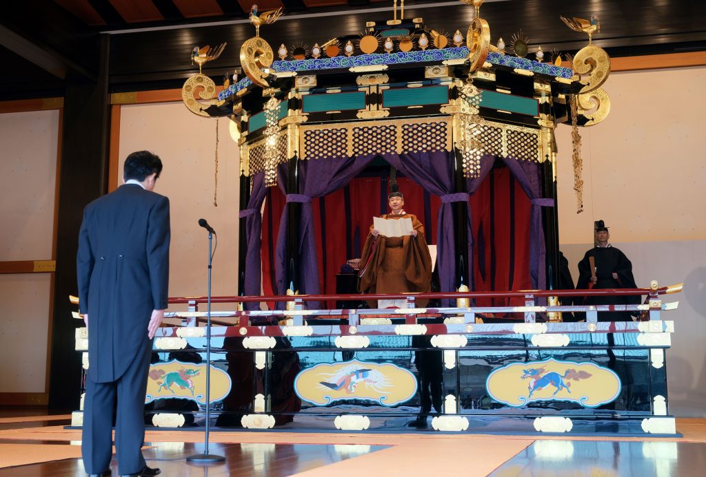 In this handout picture released by Japanese Government on October 22, 2019 Prime Minister Shinzo Abe (L) listens to the speech of Emperor Naruhito (C) during the enthronement ceremony in Tokyo. (AFP)