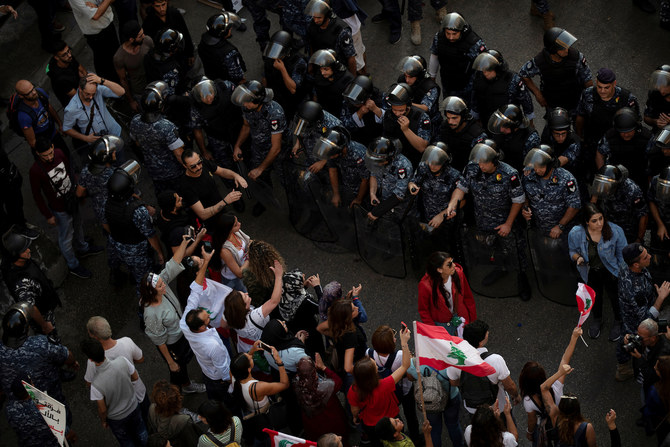Anti-government protesters block the main highway linking east and west Beirut by tents, stones and bricks during a protest in Beirut, Lebanon, Friday, Oct. 25, 2019. (AP)