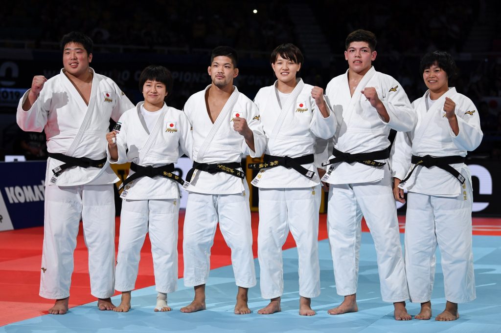Japan’s team celebrate their victory against France after the final of the mixed teams event at the 2019 Judo World Championships in Tokyo on September 1, 2019. (AFP)