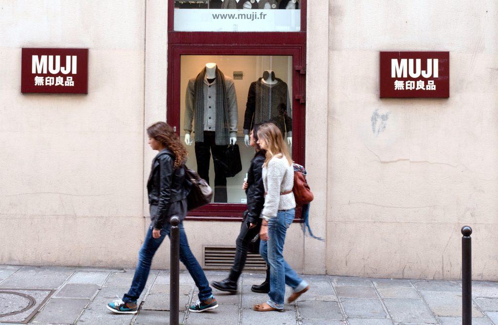People walk past a Japanese brand Muji shop in Saint-Germain-des-Prés, an area of the 6th arrondissement in central Paris on October 8, 2010. (AFP)