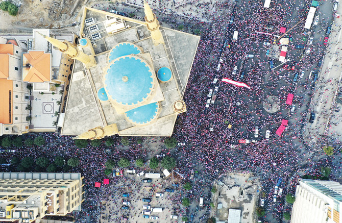 Protesters rally in Beirut on the fourth day of demonstrations against Lebanon’s government amid calls for a sweeping political overhaul. (AFP )