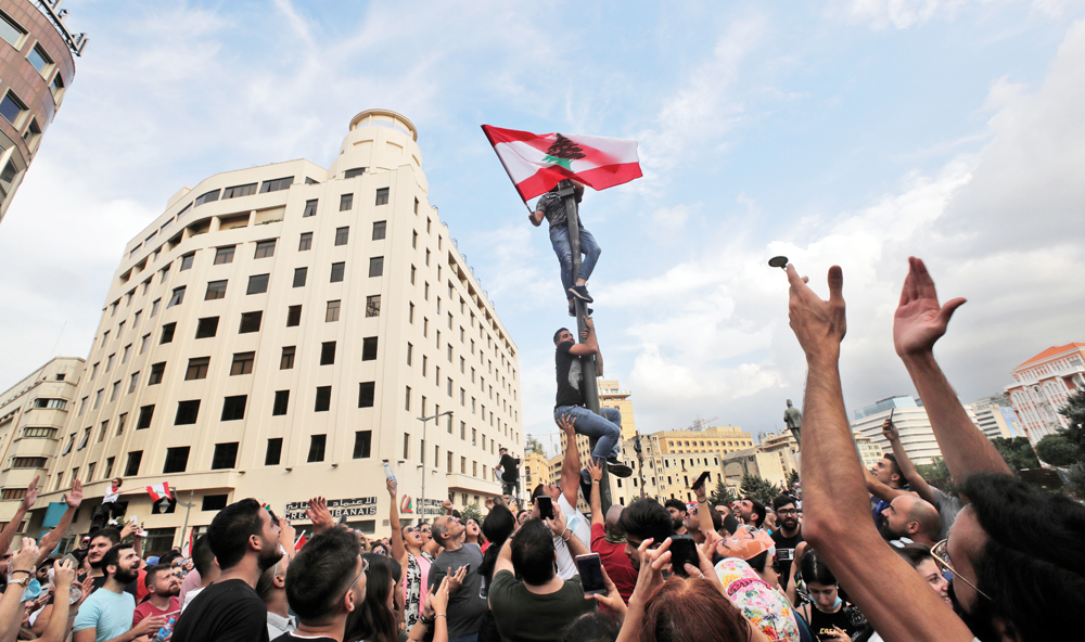 Lebanese demonstrators gather during a mass protest in the centre of the capital Beirut on October 18, 2019 against dire economic conditions. (Photo by ANWAR AMRO / AFP)