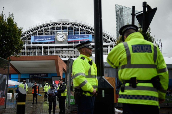 Conservative Party branded banners and police are seen outside Manchester Central convention centre, the venue of the annual Conservative Party conference, in Manchester, on September 28, 2019 on the eve of the start of the conference. (AFP)