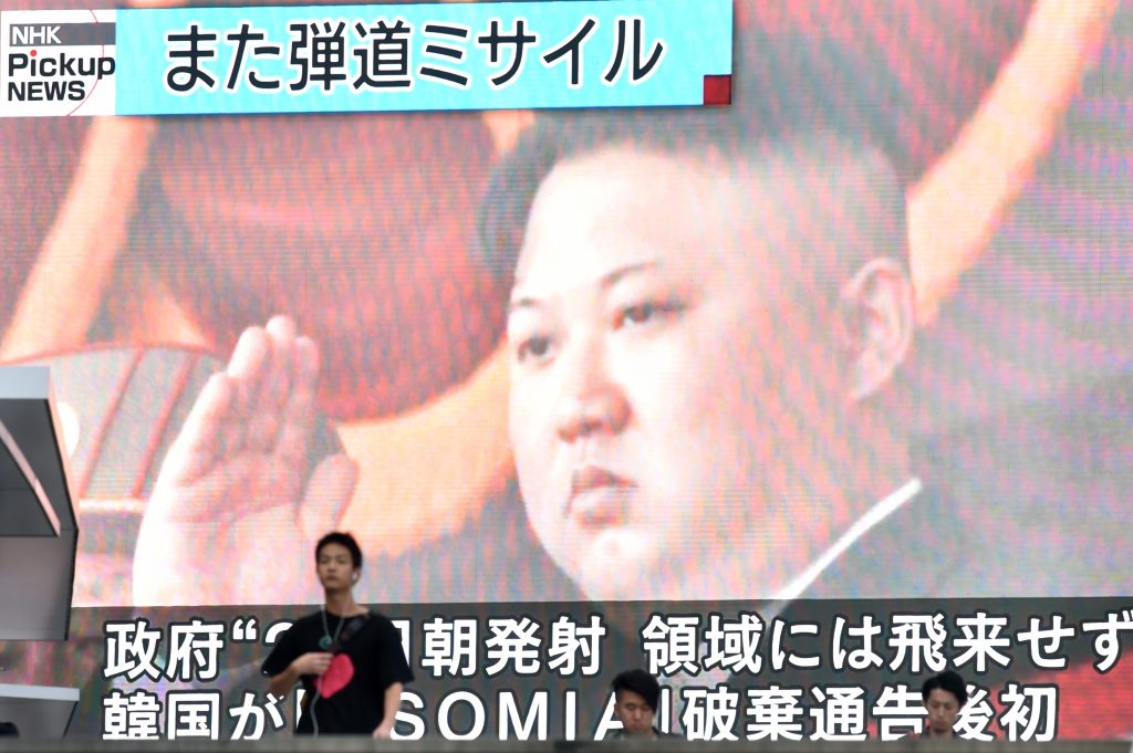 Footage of North Korea's leader Kim Jong Un is seen on a giant television screen in Tokyo on August 24, 2019, reporting on North Korea's missile launch earlier in the day. (AFP)
