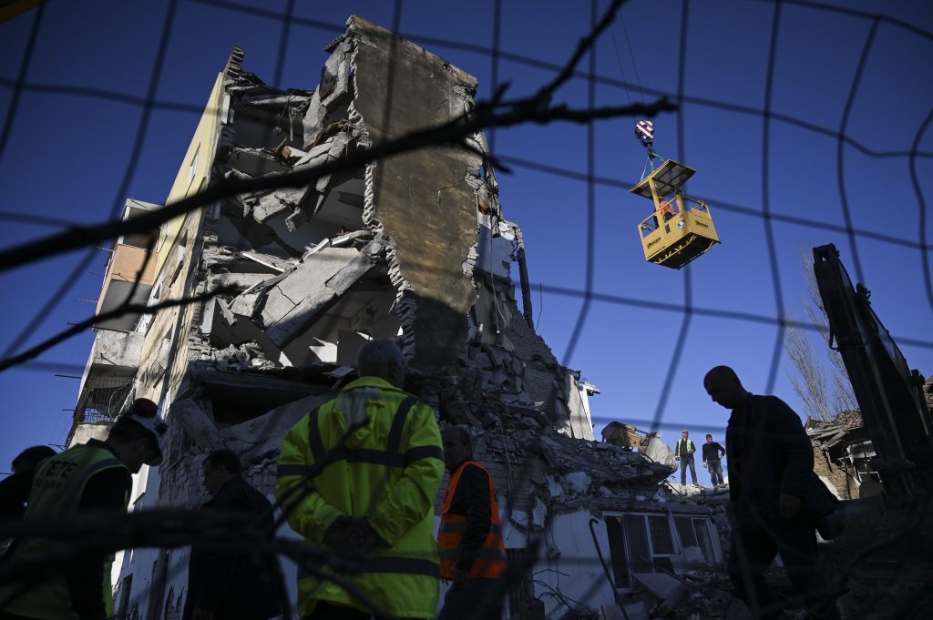 Rescue workers remove debris from a collapsed building in Thumane, northwest of capital Tirana, after an earthquake hit Albania, on November 26, 2019. (AFP) 