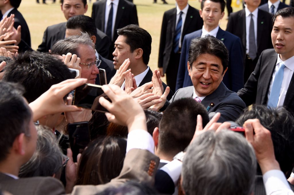 Japan’s Prime Minister Shinzo Abe (2nd R) greeting people during the cherry blossom viewing party in Tokyo on April 15, 2017. (File photo/AFP)