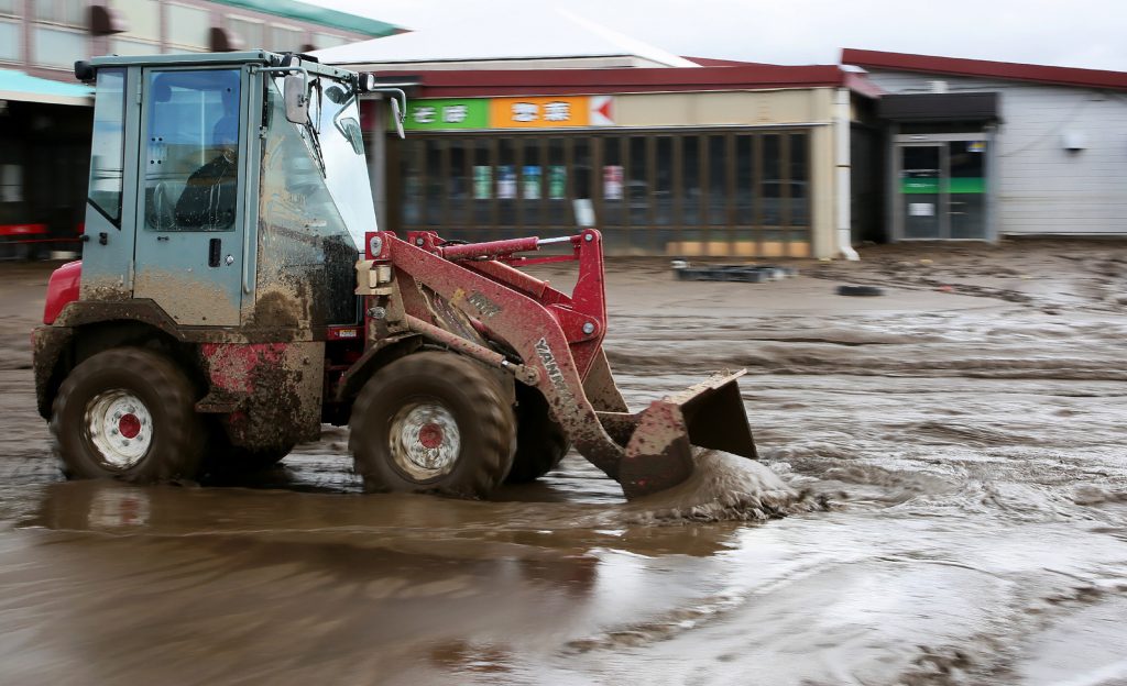 A bulldozer cleans mud at a flood-affected area in Nagano on October 15, 2019 after Typhoon Hagibis hit Japan on October 12. (AFP file)