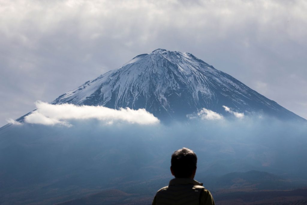 A tourist looks at Mount Fuji, the highest mountain in Japan, from Fujikawaguchiko, Yamanashi prefecture on November 1, 2018. (AFP)
