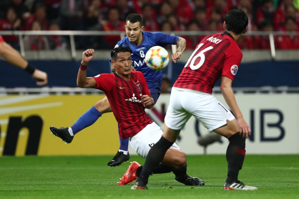 Al-Hilal’s Abdullah Otayf (behind in blue) clashes with Urawa’s Tomoaki Makino (C-in red) during the second leg of the AFC Champions League final football match at Saitama Stadium in Saitama on November 24, 2019. (AFP)