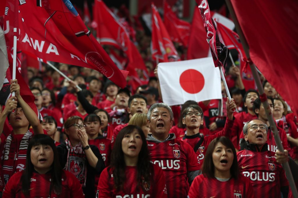 Supporters of the Urawa Reds football team sing and wave banners before the start of the second leg of the AFC Champions League final football match between Japan’s Urawa Red Diamonds and Saudi’s Al-Hilal at Saitama Stadium in Saitama on November 24, 2019. (AFP)