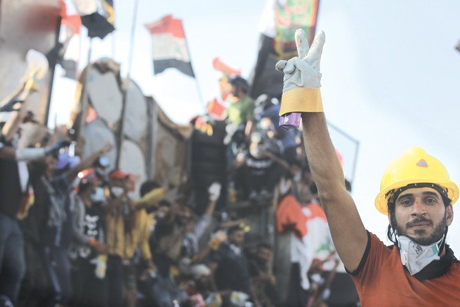 An Iraqi protester flashes the victory sign during ongoing anti-government demonstrations on Al-Jumhuriya bridge which leads to the high-security Green Zone, in Baghdad on Friday. (AFP)