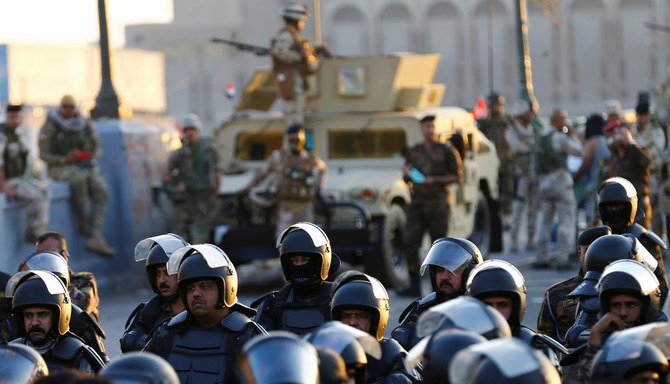 Riot police stand at Al Shuhada bridge during ongoing anti-government protests, in Baghdad, Iraq November 5, 2019. (Reuters)