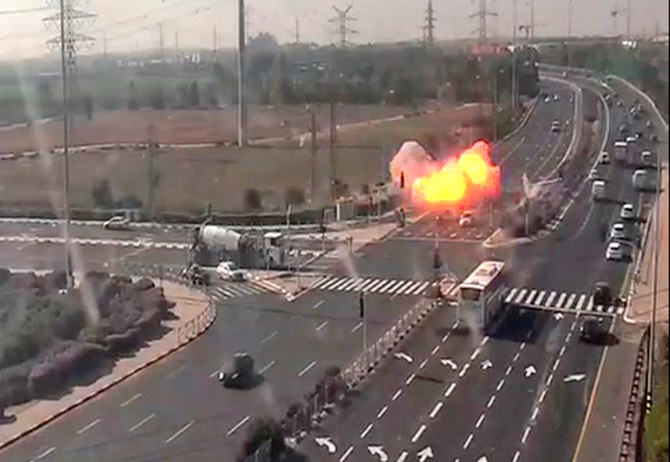 An image grab from footage taken from a CCTV camera shows the moment when a rocket fired from the Gaza Strip hit a highway narrowly missing several speeding vehicles near Israel's Gan Yavne. (AFP)