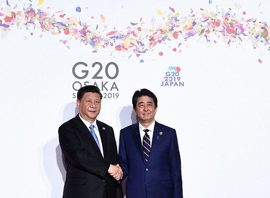Prime Minister Shinzo Abe (right) appears eager to drastically improve Japan-China ties, with Xi set to visit Japan as a state guest next spring. (AFP file)