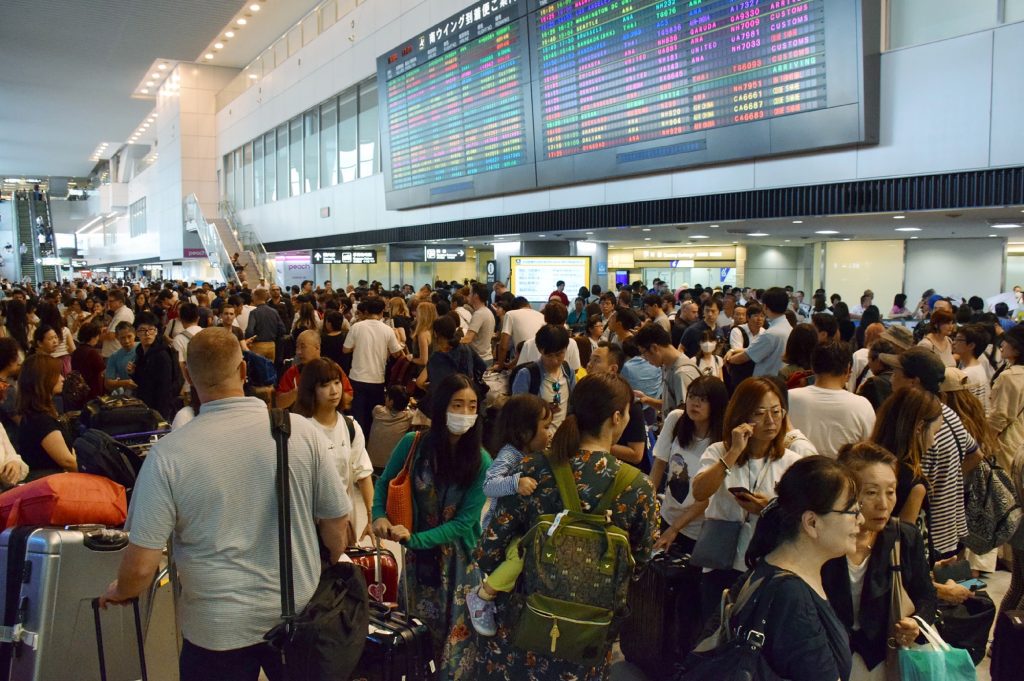 Passengers wait at the arrivals hall of Narita International Airport on September 9, 2019. (Jiji press / AFP)