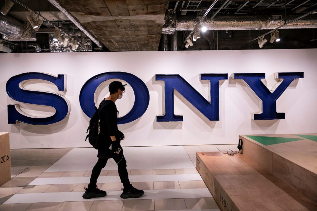 A visitor walks past a Sony logo at an exhibition marking the 40th anniversary of the Walkman portable music player, in Tokyo, on July 10, 2019. (AFP)