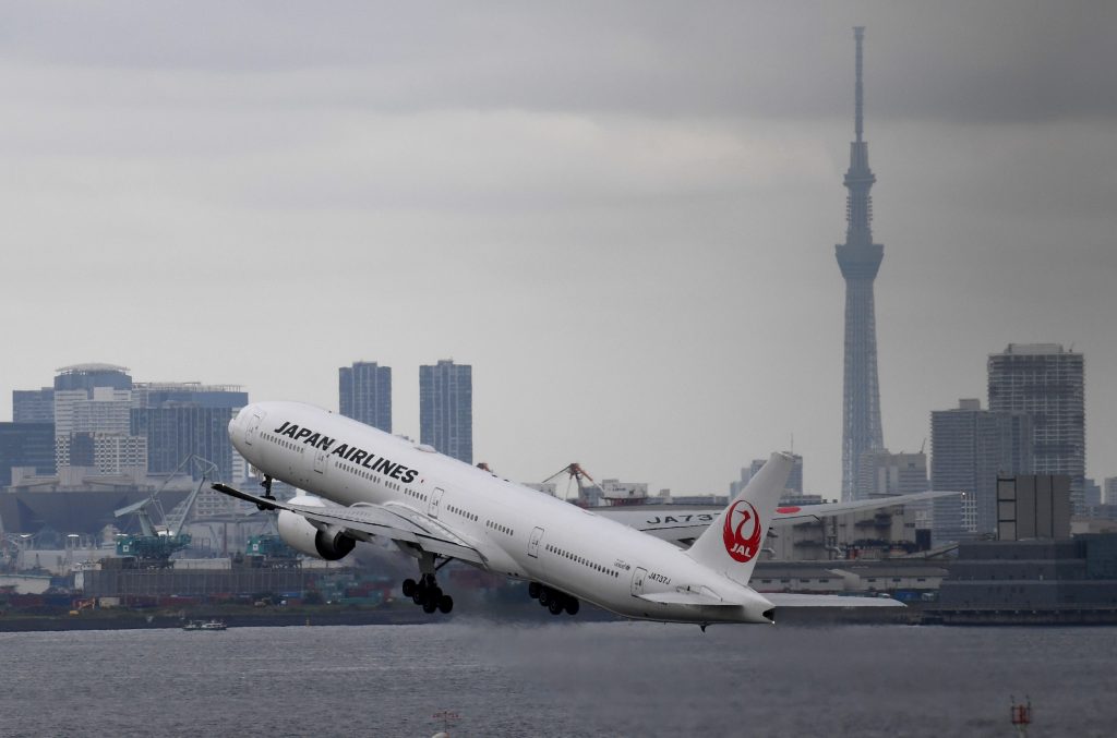 The landmark Tokyo Skytree tower is seen with the city skyline as a Japan Airlines (JAL) Boeing 777 takes off at Haneda international airport in Tokyo on August 2, 2017. (AFP)