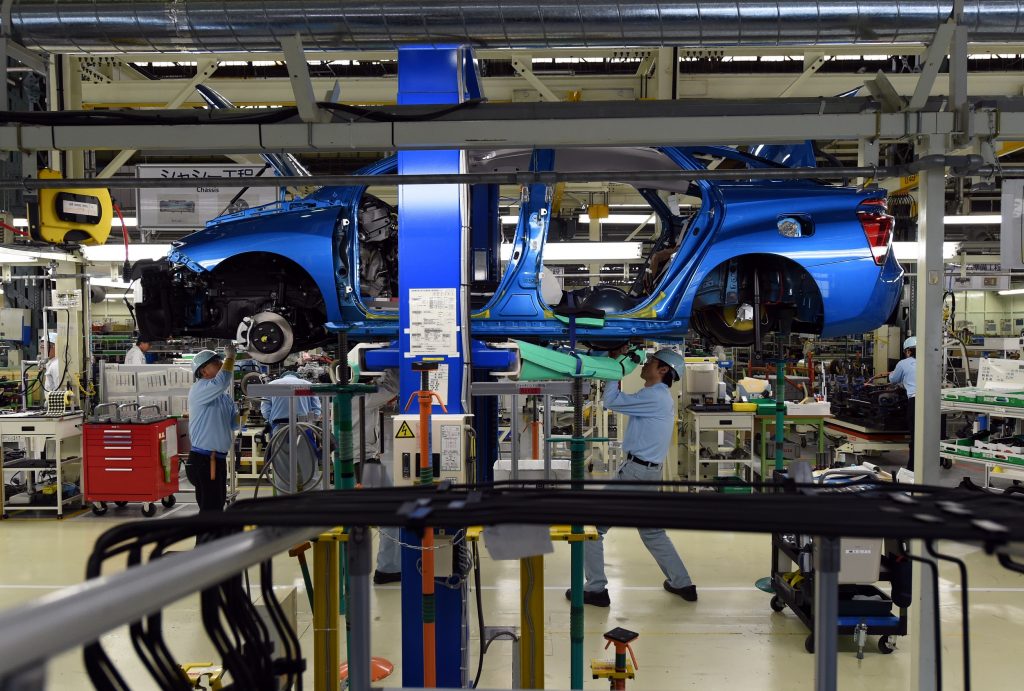 Employees of Toyota Motors assemble the FCV “Mirai” on the assembly line during the vehicle’s line off ceremony at the Motomachi factory in Toyota city, Aichi prefecture on February 24, 2015. (AFP)
