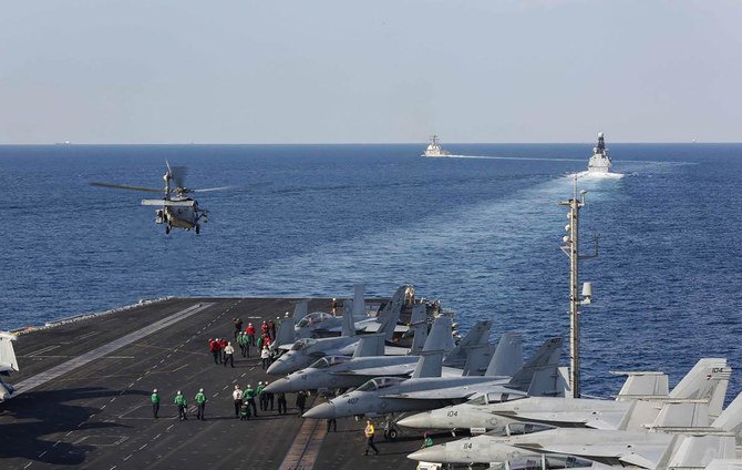 In this Tuesday, Nov. 19, 2019, photo made available by US Navy, a helicopter lifts off of the aircraft carrier USS Abraham Lincoln as it transits the Strait of Hormuz. (AP)