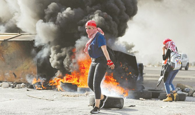 A Palestinian girl is seen during an anti-Israel protest near Beit El in the West Bank on Saturday. (Reuters)