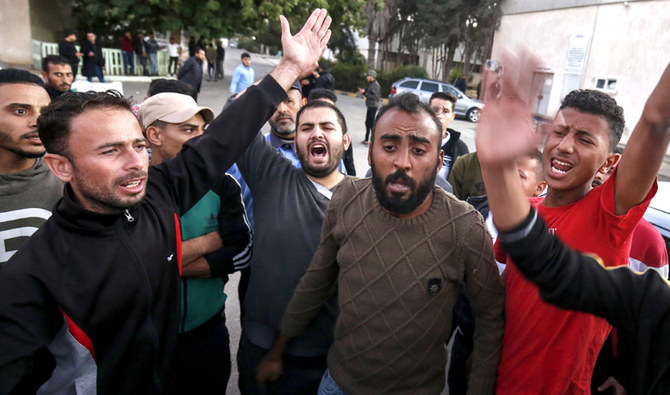 Relatives and friends of a Palestinian teenager who was killed near the border fence react as they mourn outside a hospital in Khan Yunis in the southern Gaza Strip on November 29, 2019. (AFP)