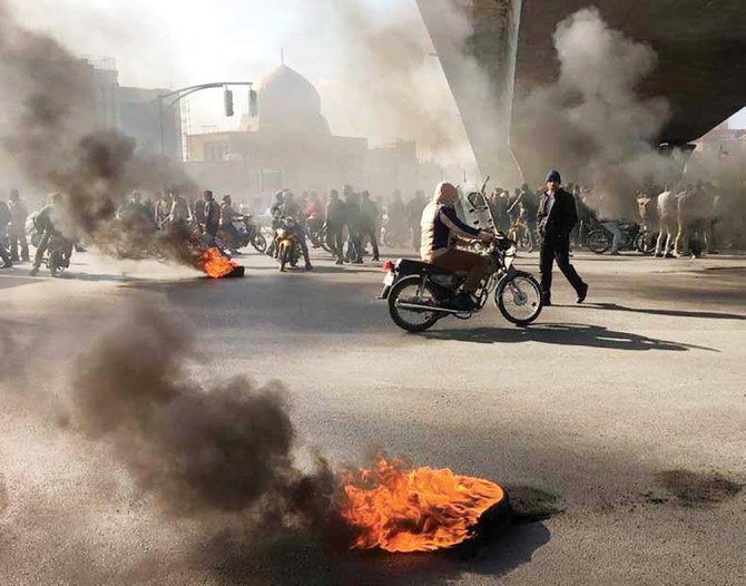 The demonstrations took place in over a dozen cities in the hours following President Rouhani’s decision at midnight on Friday to cut gasoline subsidies. (AFP)