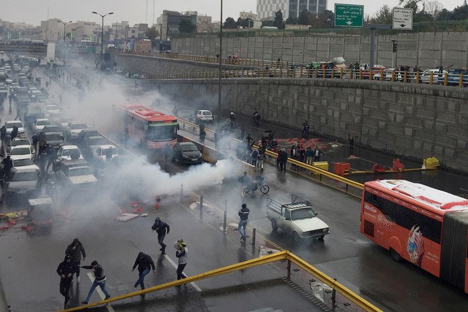 Riot police tries to disperse people as they protest on a highway against increased gas price in Tehran, Iran November 16, 2019. (Reuters)