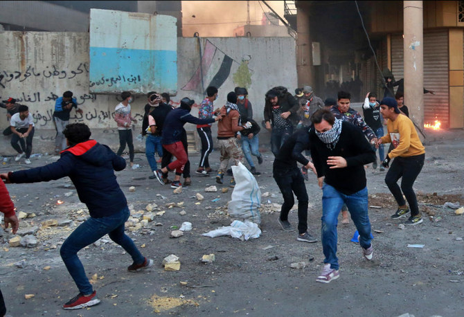 Anti-government protesters run for cover while security forces fire tear gas and live ammunition during clashes between Iraqi security forces and anti-Government protesters, in Baghdad, Iraq, Nov. 21, 2019. (AP)