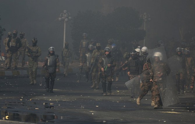 Iraqi security forces clash with demonstrators during ongoing anti-government protests in Nassiriya, Iraq on Thursday. (Reuters)