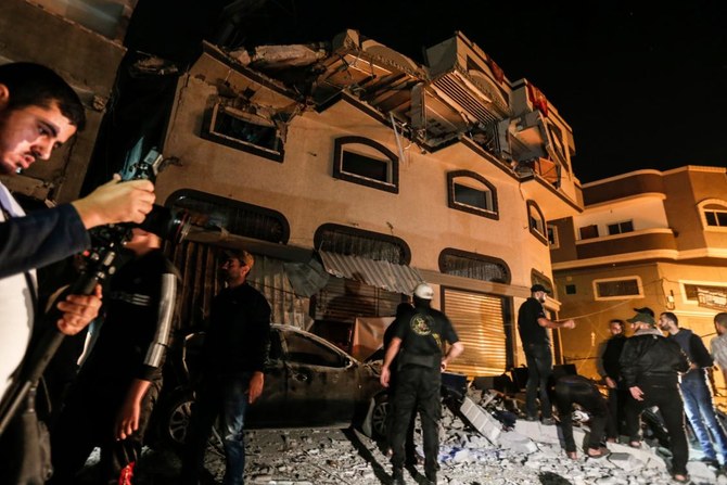 Residents inspect the damaged house of Islamic Jihad leader Baha Abu Al-Ata after an Israeli attack in Gaza city on Tuesday, November 12, 2019. (AFP)