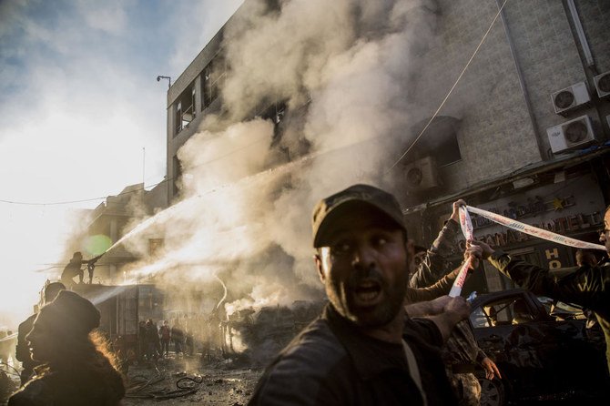 Firefighters tackle a blaze from one of the car bomb blast in the city of Qamishli Monday (AP)