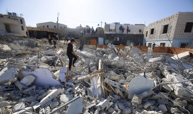 Palestinians looks at houses destroyed by the Israeli military in the village of Beit Kahil near the West Bank city of Ramallah. (AP)