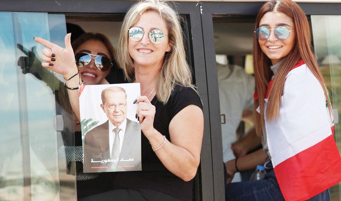 A supporter of Lebanon’s President Michel Aoun holds his poster during a demonstration in Baabda city in western Lebanon on Sunday. (Reuters)