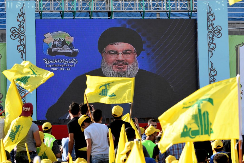 Supporters listen to an address by Hezbollah Secretary-General Hassan Nasrallah on a big screen in the Beqaa Valley. (Reuters)