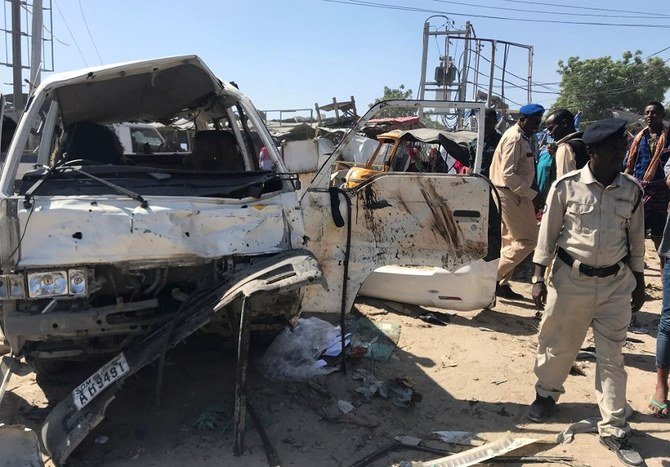 Somali security assess the scene of a car bomb explosion at a checkpoint in Mogadishu on Saturday, December 28, 2019. (Reuters)