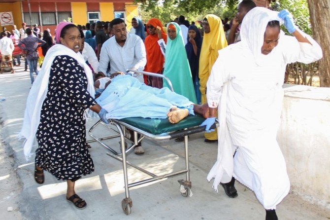 A wounded man is carried on a stretcher at Medina hospital in Mogadishu, Somalia on Saturday, Dec. 28, 2019. (Reuters)
