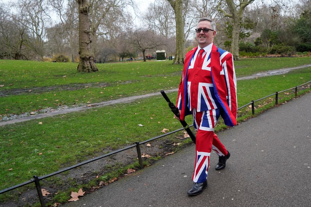 A man in a Union Jack suit walks in Green park, London on December 13, 2019. (AFP)