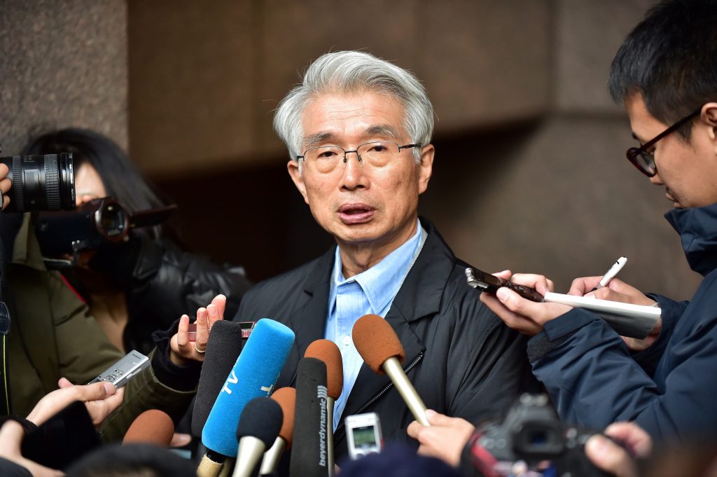 The Japanese lawyer for Carlos Ghosn, Junichiro Hironaka (C), speaks to the media outside his office in Tokyo on December 31, 2019. (AFP)