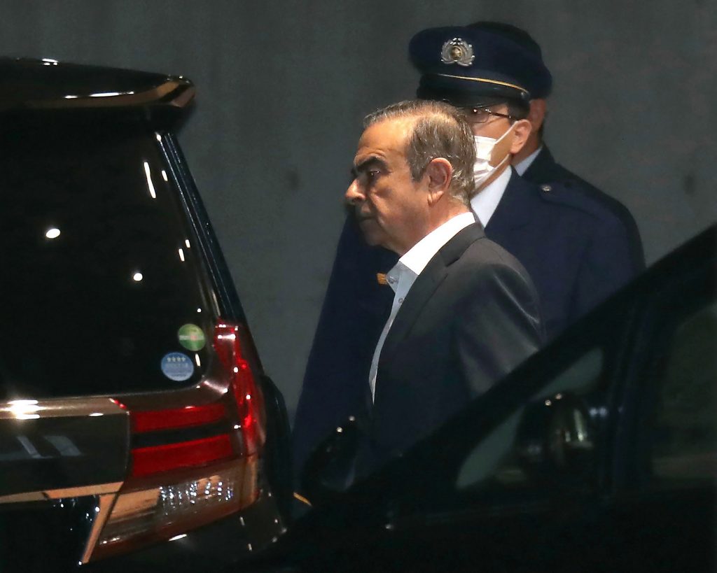Carlos Ghosn (C) walks out of the Tokyo Detention House following his release on bail in Tokyo on April 25, 2019. (Jiji Press/AFP)