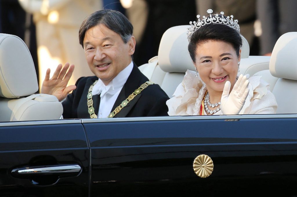 Japan’s Emperor Naruhito and Empress Masako wave during a royal parade in Tokyo on November 10, 2019. (AFP/file)