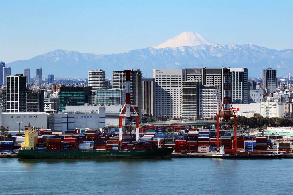 Mount Fuji is seen behind an international cargo terminal in Tokyo on January 25, 2016. (AFP)