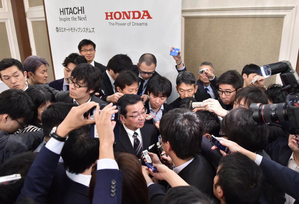 Takahiro Hachigo (C) answers questions following a press conference in Tokyo on February 7, 2017. (AFP)