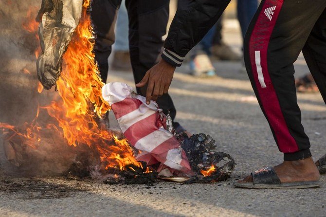 Some Iraqi protesters threw stones at the gate while others chanted, “No, no, America! ... No, no, Trump!.” (File/AFP)