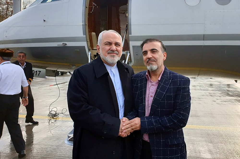 A handout picture released by the Iranian Foreign Minister's official Twitter account on December 7, 2019, shows Foreign Minister Mohammad Javad Zarif (left) and Iranian scientist Massoud Soleimani standing by a plane at an undisclosed location. (AFP/file)